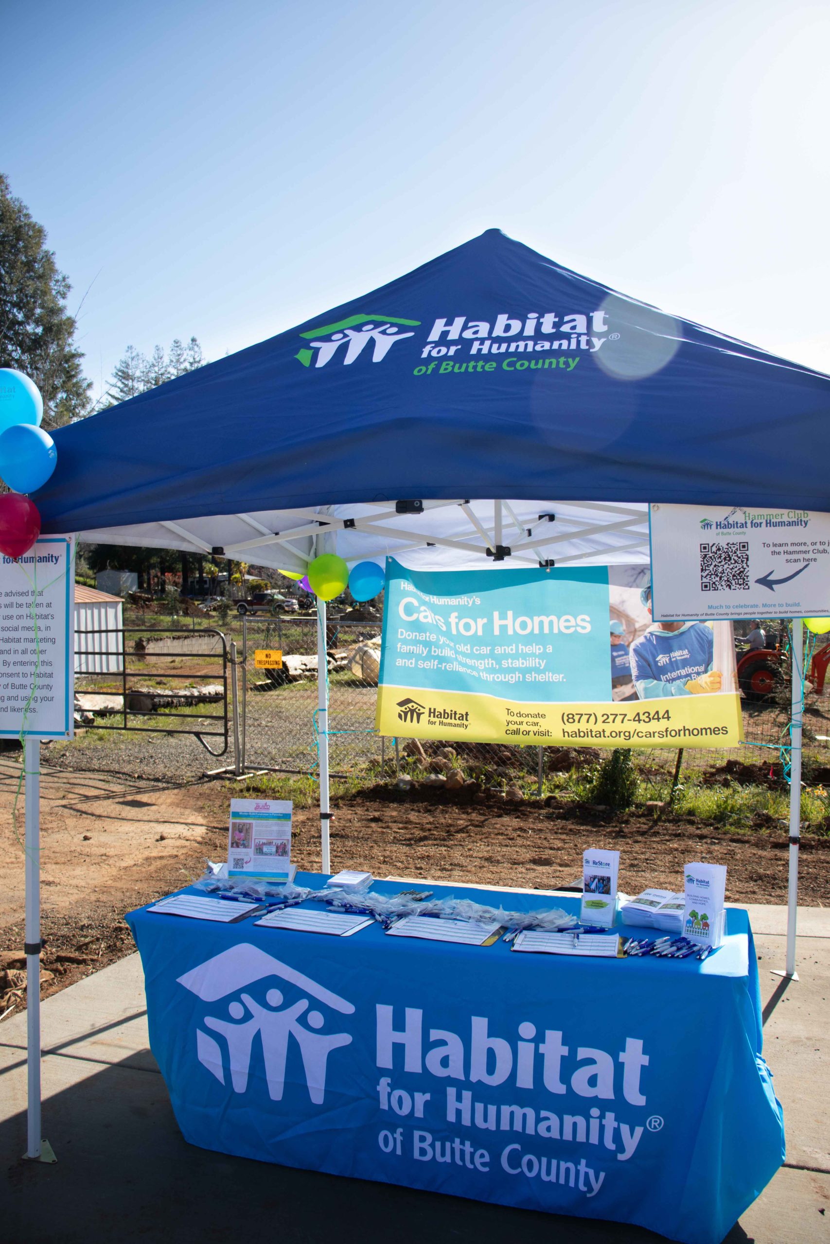 Habitat for Humanity tent with a Cars for Homes banner